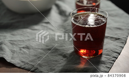 chinotto soft drink in tumbler glass on linen cloth chinotto soft drink in tumbler glass on linen cloth 84370908