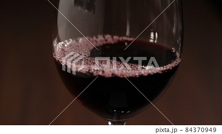 pour red wine into wineglass closeup pour red wine into wineglass closeup 84370949