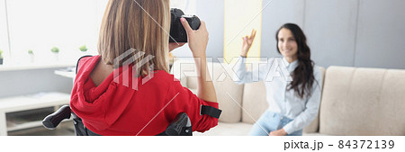 Disabled woman in wheelchair photographing model at home Disabled woman in wheelchair photographing model at home 84372139