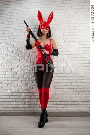 asian girl in a red rabbit mask and a sexy red bodysuit with a shotgun in the image of a superhero asian girl in a red rabbit mask and a sexy red bodysuit with a shotgun in the image of a superhero 84372904