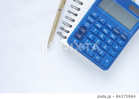 Top view of note pad, calculator, pen on white background. Top view of note pad, calculator, pen on white background. 84375064