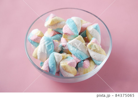 marshmallow candy in a bowl on blue  84375065