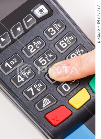 Hand of woman using credit card reader to enter PIN code. Cashless paying. Finance and banking Hand of woman using credit card reader to enter PIN code. Cashless paying. Finance and banking 84375737