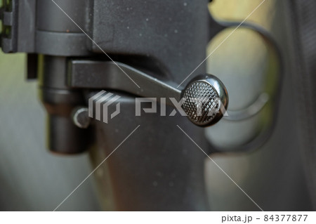 Close-up parts of automatic weapon with selective focus and blurred background Close-up parts of automatic weapon with selective focus and blurred background 84377877