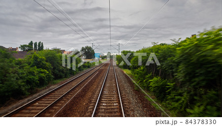 Point of view train travel under cloudy sky Point of view train travel under cloudy sky 84378330