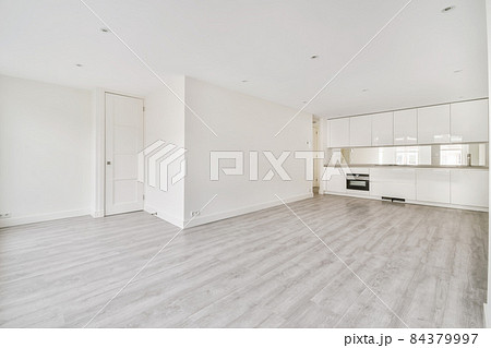 Interior of empty home kitchen with contemporary appliances. A large studio apartment with kitchen and white walls 84379997