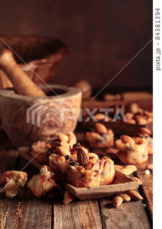 Small cakes with almonds, raisins, and honey. Small cakes with almonds, raisins, and honey. 84381394