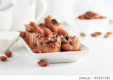 Small cakes with almonds, raisins, and honey. Small cakes with almonds, raisins, and honey. 84381395