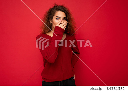 Photo of young shocked amazed attractive brunette curly woman with sincere emotions wearing casual Photo of young shocked amazed attractive brunette curly woman with sincere emotions wearing casual 84381582