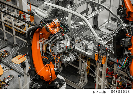 Car bodies are on assembly line. Factory for production of cars. Modern automotive industry Car bodies are on assembly line. Factory for production of cars. Modern automotive industry 84381618