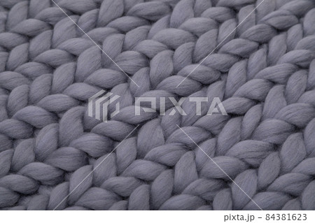 gray knitted wool blanket, concept of warmth and comfort gray knitted wool blanket, concept of warmth and comfort 84381623