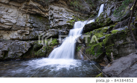 Small cascade waterfall hidden in a forest, Canadian Rockies, Canada Small cascade waterfall hidden in a forest, Canadian Rockies, Canada 84384852