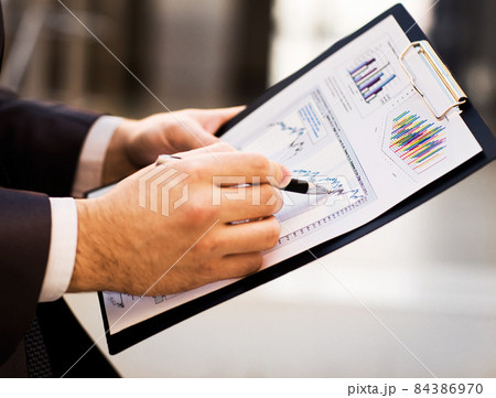 Close-up of female and male hands pointing at business document while discussing it Close-up of female and male hands pointing at business document while discussing it 84386970