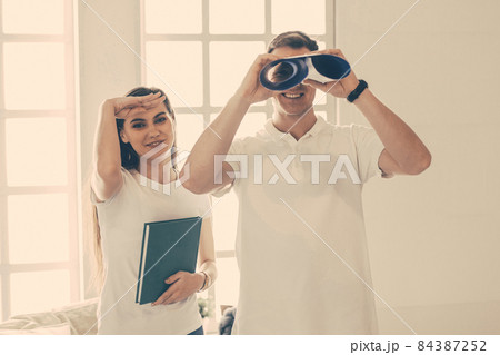 female designer and a young man standing in an empty room. 84387252