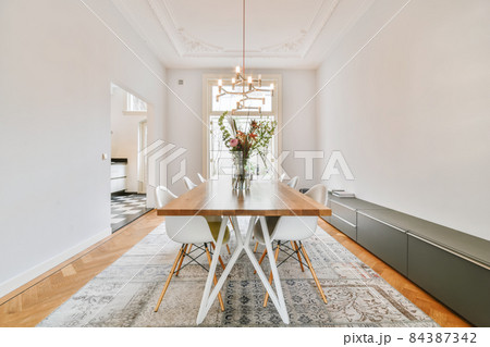 Spacious dining room with table and chairs in modern apartment in minimal style 84387342