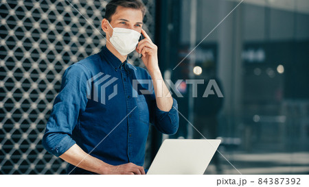 close up. casual young man in a protective mask on a city street 84387392