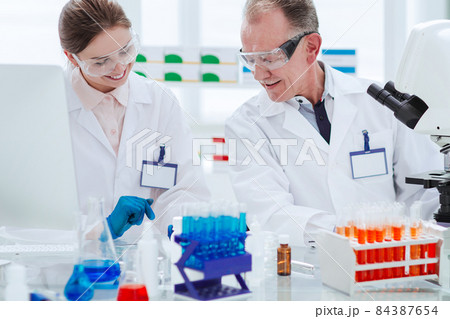 close up. scientists work in the laboratory for blood research. 84387654