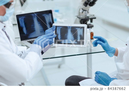 close up. medical colleagues using a digital tablet in the lab . 84387662