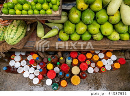 Green Fruits and Jars with Sauces on a Local Market in Dar es Salaam, Tanzania 84387951
