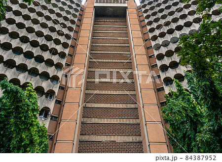 Post-Modern Investment House. concrete triangle high building with arc panels in Dar es Salaam, Tanzania 84387952