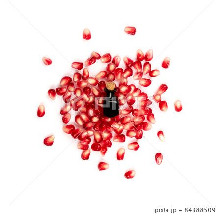 Pomegranate Oil and Seeds Isolated on White Background 84388509