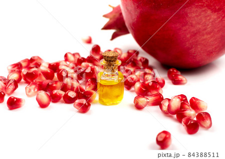 Pomegranate Oil and Seeds Isolated on White Background Pomegranate Oil and Seeds Isolated on White Background 84388511