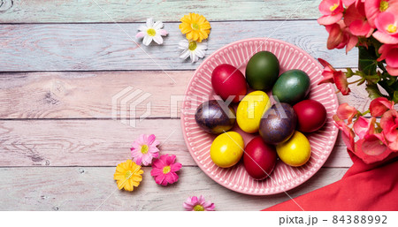 Colorful Easter eggs on pink plate 84388992