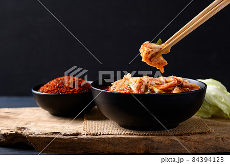 Korean kimchi cabbage in a bowl eating by chopsticks, Asian fermented food, Still Life 84394123