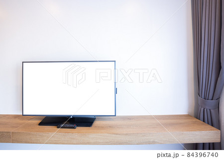 Monitor led television or TV with empty white screen beside the window on brick wall interior room in hotel 84396740