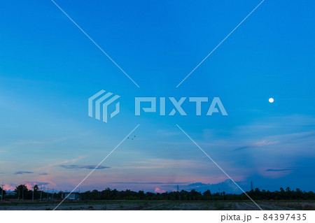 dusk Twilight blue bright dramatic sunset sky and moon in countryside or beach colorful cloudscape texture with white clouds air background. dusk Twilight blue bright dramatic sunset sky and moon in countryside or beach colorful cloudscape texture with white clouds air background. 84397435
