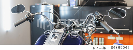 Front of motorcycle at service station closeup Front of motorcycle at service station closeup 84399042