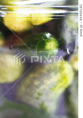 glass jar with a pickled cucumbers. gherkins cucumbers background. glass jar with a pickled cucumbers. gherkins cucumbers background. 84400182