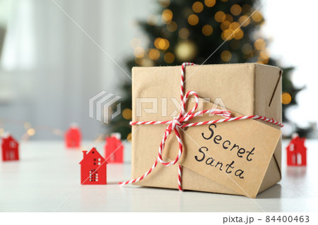 Secret Santa and Christmas composition on white wooden table Secret Santa and Christmas composition on white wooden table 84400463