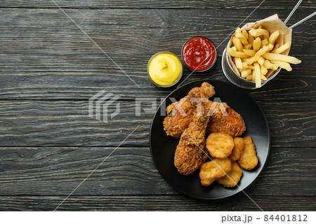 Concept of tasty eating with fried chicken on wooden background Concept of tasty eating with fried chicken on wooden background 84401812
