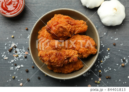 Concept of tasty eating with fried chicken on dark wooden background Concept of tasty eating with fried chicken on dark wooden background 84401813