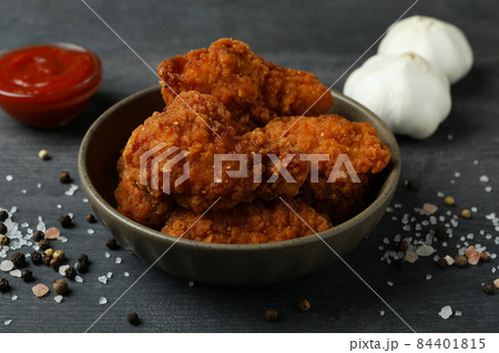 Concept of tasty eating with fried chicken on dark wooden background 84401815