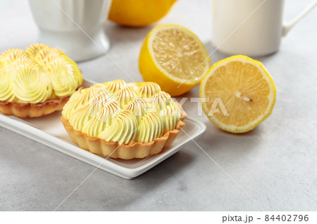 Tartlets with lemon cream on a white table. 84402796