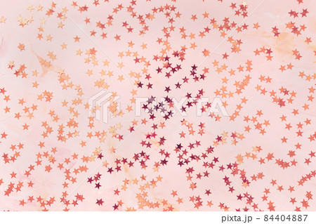 Trendy rose gold and bronze foil confetti stars on pink background. Christmas festive abstract background. Birthday party, New Year, Christmas celebration, holidays, winter concept Trendy rose gold and bronze foil confetti stars on pink background. Christmas festive abstract background. Birthday party, New Year, Christmas celebration, holidays, winter concept 84404887