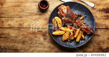 Turkey leg with orange, fried meat 84406962