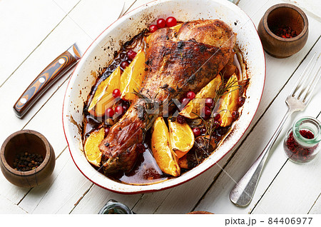 Turkey leg with orange, fried meat 84406977