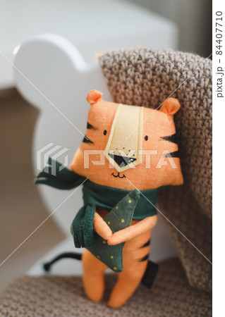 cute soft toy tiger - symbol of 2022, oriental calendar concept cute soft toy tiger - symbol of 2022, oriental calendar concept 84407710