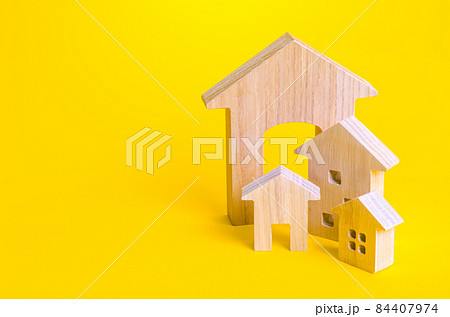 Figures of residential buildings on a yellow background. Affordable housing. Search best option apartment and real estate, rent. Purchase of housing. Mortgage loan. 84407974