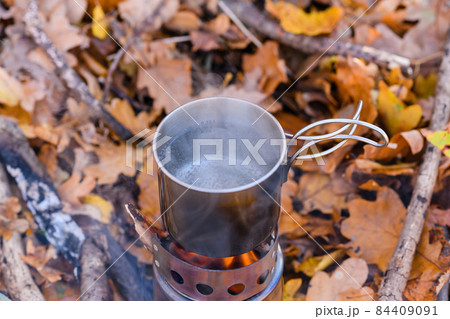 Top view of a metal mug with boiling water 84409091
