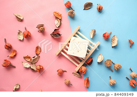 Homemade natural soap bar and dry flower on black background Homemade natural soap bar and dry flower on black background 84409349