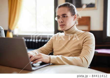 Man studying on laptop Man studying on laptop 84411412