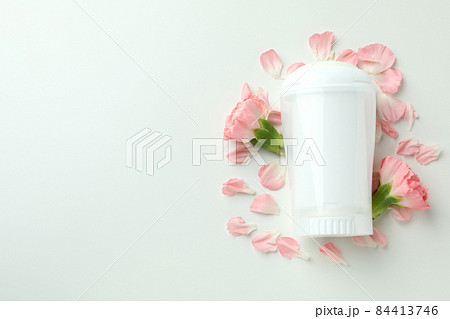 Blank deodorant and flower petals on white background Blank deodorant and flower petals on white background 84413746