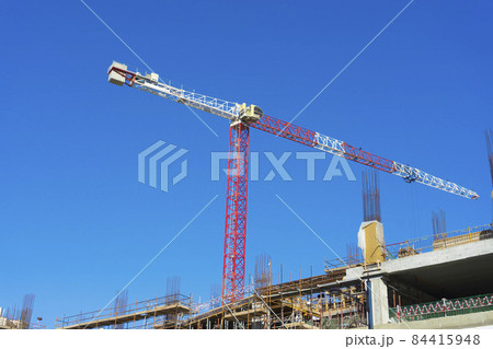 Crane and building construction site. Construction site with crane and building.  84415948