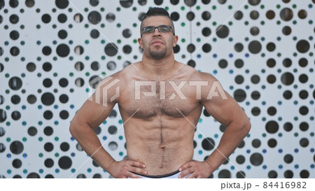 Muscular young man Arab posing against white background. 84416982