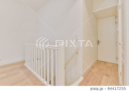 Luxurious bright room with parquet floor and staircase 84417250