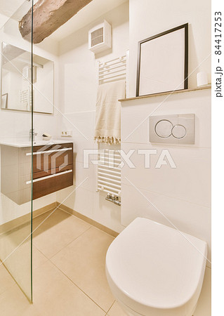 Luxurious restroom with hanging toilet and portrait on the shelf 84417253